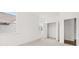Bedroom with neutral carpet, white trim and walls, with a view of a closet and windows at 51 Black Rock Rdg, Sharpsburg, GA 30277
