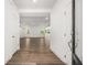 Welcoming entryway with hardwood floors, a view into the open-concept living area, and white trim at 51 Black Rock Rdg, Sharpsburg, GA 30277