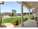 Inviting front porch view with white columns overlooking the landscaped front yard and street at 51 Black Rock Rdg, Sharpsburg, GA 30277