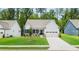 Charming single-Gathering home featuring a well-manicured lawn and a two-car attached garage at 51 Black Rock Rdg, Sharpsburg, GA 30277