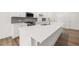 Bright kitchen with white cabinets, stainless steel appliances, and a large center island with white countertop at 51 Black Rock Rdg, Sharpsburg, GA 30277