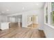 Spacious living room with kitchen access, sliding glass door to deck, and large windows for natural light at 51 Black Rock Rdg, Sharpsburg, GA 30277