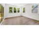 Bright living room with wood floors, natural light from several windows, and direct access to the backyard at 51 Black Rock Rdg, Sharpsburg, GA 30277