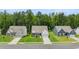 Street view of newly built homes featuring manicured lawns and wide driveways in quiet neighborhood at 51 Black Rock Rdg, Sharpsburg, GA 30277