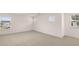 Well-lit bedroom featuring plush carpeting and multiple windows at 575 Silver Moon Dr, Loganville, GA 30052