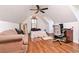 Finished attic space with hardwood floors, a desk, and a comfortable sofa at 737 Wilkes Dr, Loganville, GA 30052
