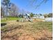 Large backyard featuring a swing set, slide, and above-ground pool, offering endless outdoor fun for the Gathering at 737 Wilkes Dr, Loganville, GA 30052
