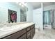 Bright bathroom featuring a double sink vanity, closet, and tiled floors at 737 Wilkes Dr, Loganville, GA 30052