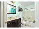 A well-lit bathroom with a shower-tub combo and vanity at 737 Wilkes Dr, Loganville, GA 30052