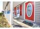 The front door of the house has a white frame, and a large oval glass in the middle, flanked by windows with red shutters at 737 Wilkes Dr, Loganville, GA 30052