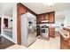 Well-equipped kitchen featuring stainless steel appliances, ample cabinet space, and tiled floors for easy maintenance at 737 Wilkes Dr, Loganville, GA 30052