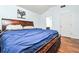 A primary bedroom with hardwood floors and neutral wall colors at 737 Wilkes Dr, Loganville, GA 30052