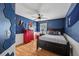 Nautical-themed bedroom with a dark blue walls, hardwood floors, and plenty of natural light at 2508 Haddenham Sw Ln, Smyrna, GA 30082