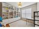 Bedroom with built-in white shelving, a work table, and a neutral rug at 2508 Haddenham Sw Ln, Smyrna, GA 30082