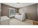 Neutral room featuring light brown walls, a comfy bed, and a bright window for natural light at 2508 Haddenham Sw Ln, Smyrna, GA 30082