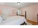 Bedroom with hardwood floors featuring a four-poster bed and light pink walls at 2508 Haddenham Sw Ln, Smyrna, GA 30082