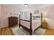 Charming bedroom featuring hardwood floors, a four-poster bed with bedside tables, and bright natural light at 2508 Haddenham Sw Ln, Smyrna, GA 30082