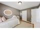 Bedroom with light brown walls featuring a comfy bed and dual closets at 2508 Haddenham Sw Ln, Smyrna, GA 30082