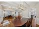 Spacious dining room adjacent to an office features hardwood floors and a modern light fixture at 2508 Haddenham Sw Ln, Smyrna, GA 30082