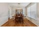 Formal dining room with hardwood floors, a dark wood table, and a modern chandelier fixture at 2508 Haddenham Sw Ln, Smyrna, GA 30082