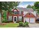 Charming two-story brick home with attached two-car garage and manicured landscaping at 2508 Haddenham Sw Ln, Smyrna, GA 30082