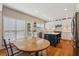 Bright kitchen features white cabinets, a blue island, stainless steel appliances, and a wood dining table set at 2508 Haddenham Sw Ln, Smyrna, GA 30082