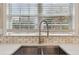 Close-up of kitchen sink with stainless steel faucet and white quartz countertops at 2508 Haddenham Sw Ln, Smyrna, GA 30082