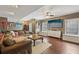Bright living room features hardwood floors, a plush sofa, and large windows for ample natural light at 2508 Haddenham Sw Ln, Smyrna, GA 30082