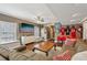 Spacious living room featuring a plush sofa, entertainment center, and sports memorabilia at 2508 Haddenham Sw Ln, Smyrna, GA 30082