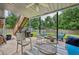 Relaxing covered patio featuring comfortable seating, a fire pit, and serene backyard views at 2508 Haddenham Sw Ln, Smyrna, GA 30082
