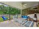 Inviting covered patio with stylish seating, ceiling fan, and outdoor entertaining area at 2508 Haddenham Sw Ln, Smyrna, GA 30082