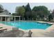 Community pool featuring lounge chairs and tables with ample seating under a shaded patio at 2508 Haddenham Sw Ln, Smyrna, GA 30082