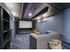 Home theater with tiered seating, projector screen, and cozy gray sectional at 2508 Haddenham Sw Ln, Smyrna, GA 30082