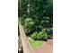 View of the backyard landscaping from a home deck, complete with a bird feeder at 6695 Grove Meadows Ln, Cumming, GA 30028