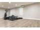 Basement workout area with an elliptical machine and weight bench at 6695 Grove Meadows Ln, Cumming, GA 30028