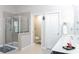 The bathroom features a modern glass shower, sleek vanity, and convenient water closet in a serene setting at 6695 Grove Meadows Ln, Cumming, GA 30028