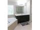 This bathroom offers a soaking tub, modern vanity, and a glass-enclosed shower for a luxurious retreat at 6695 Grove Meadows Ln, Cumming, GA 30028