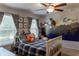 Cozy bedroom featuring playful decor, window, and a ceiling fan perfect for and guests at 6695 Grove Meadows Ln, Cumming, GA 30028