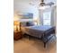 Serene bedroom featuring stylish decor, window, and ceiling fan creates a tranquil and inviting space at 6695 Grove Meadows Ln, Cumming, GA 30028