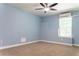 Bedroom featuring light blue walls, a ceiling fan, and natural light at 6695 Grove Meadows Ln, Cumming, GA 30028