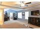 Large primary bedroom suite featuring carpet, a tray ceiling, and natural light at 6695 Grove Meadows Ln, Cumming, GA 30028