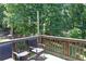 Outdoor deck space featuring a seating area and lovely views of the tree-filled backyard at 6695 Grove Meadows Ln, Cumming, GA 30028