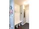 Functional mudroom featuring a built-in bench with storage hooks, wainscoting and neutral paint at 6695 Grove Meadows Ln, Cumming, GA 30028