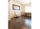 Bright room with hardwood floors, chandelier, and large mirror reflecting natural light at 6695 Grove Meadows Ln, Cumming, GA 30028