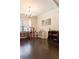 Spacious room with hardwood floors, chandelier, and large window offering natural light at 6695 Grove Meadows Ln, Cumming, GA 30028