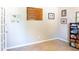 Cozy room with carpet, a window, and wall decor, perfect for an office or den at 6695 Grove Meadows Ln, Cumming, GA 30028