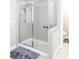 Modern glass-enclosed shower with tiled walls and chrome fixtures for a sleek and easy-to-maintain bathroom at 6695 Grove Meadows Ln, Cumming, GA 30028