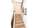 Carpeted staircase with wood railings and decorative artwork along the wall at 6695 Grove Meadows Ln, Cumming, GA 30028
