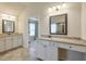 Bathroom with double vanities, granite counters, framed mirrors, tile floors, and neutral walls at 1211 Fawndale Nw Dr, Kennesaw, GA 30152
