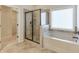 Neutral bathroom featuring a tub and a tiled glass enclosed shower with a window view at 1211 Fawndale Nw Dr, Kennesaw, GA 30152